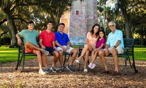 Multigenerational family sitting on a bench at Bok Tower Gardens