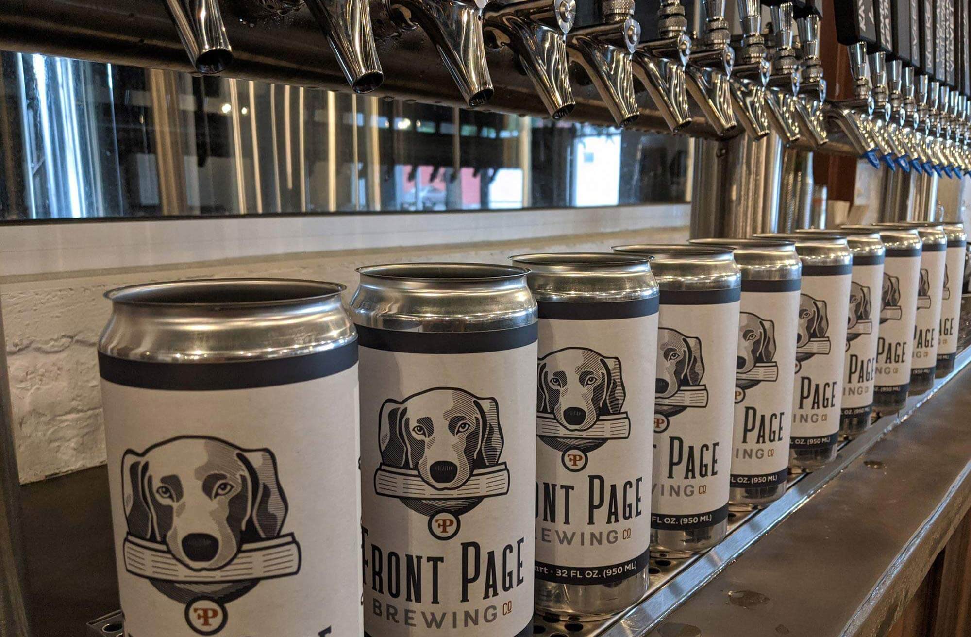 Front Page Brewing Co crowlers lined up under taps