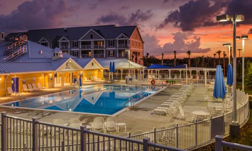 Pool, pool deck and exterior of Holiday Inn Club Vacations Orlando Breeze Resort in Davenport, FL