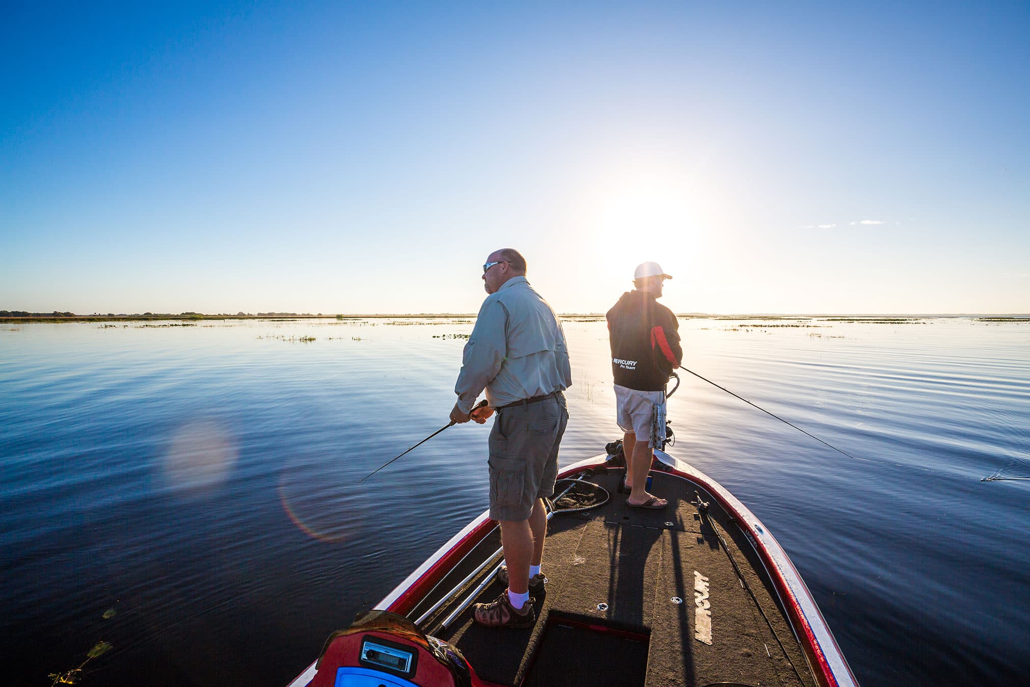 2 men from bass boat on Lake Kissimmee. TMC Guide Services