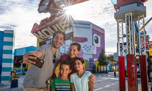 Family taking selfie in front of LEGO Movie World
