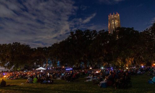 crowd gathered for moonlight concert at Bok Tower Gardens. Carillon tower in background.