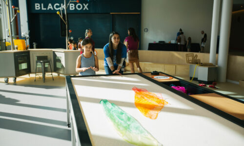 two girls playing in the design park exhibit at florida children's museum